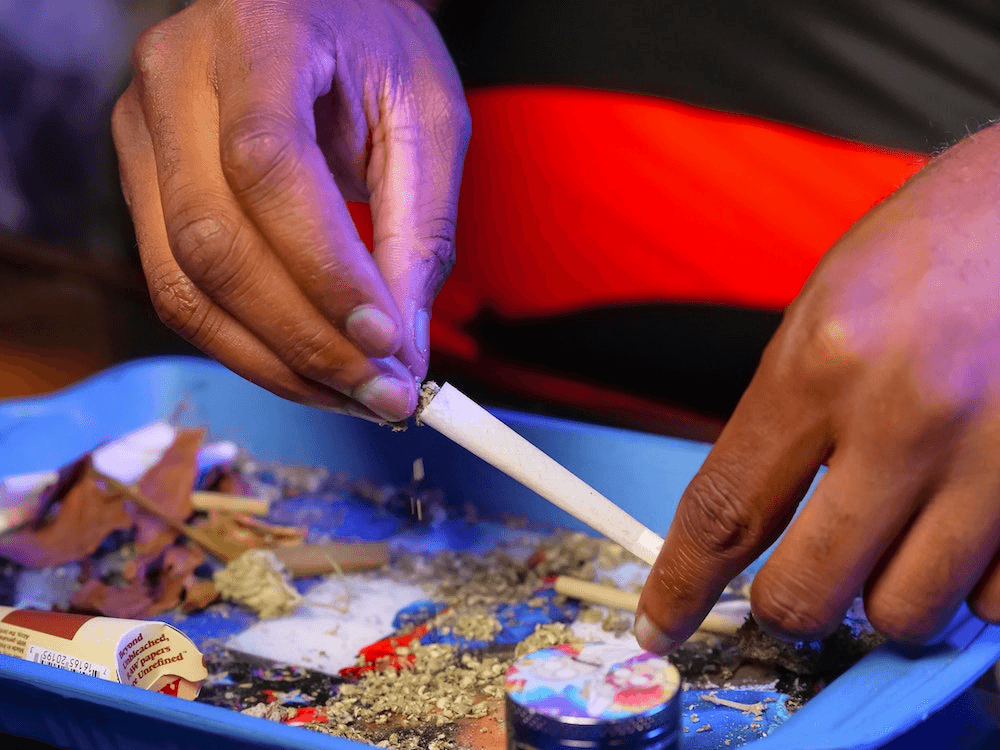 Rolling joint on tray with Raw papers or cones